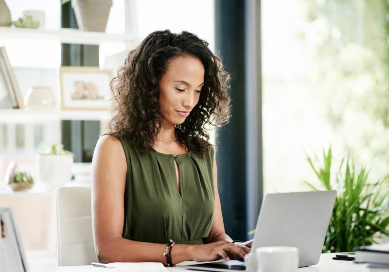 Business, typing and woman at desk, laptop and online reading for email notification. Person, writer and magazine editor in office, computer and feedback with internet and research for article